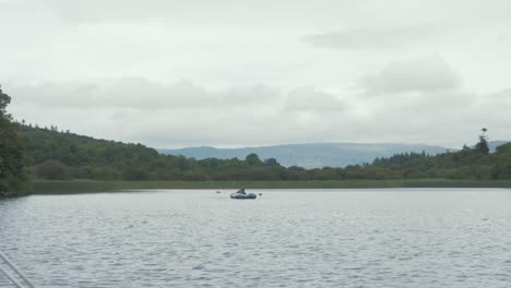small dinghy on lough gill scenic wide shot irish landscape