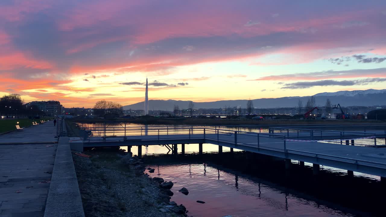 Sunset in Geneva by the boat pontoon, water jet in the background