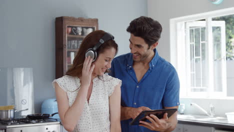 cute couple using tablet while listening to music
