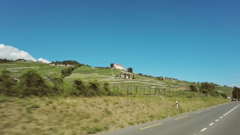 Sunny-drive-along-scenic-road-from-Lausanne-to-Montreux-with-view-of-Lavaux-vineyards