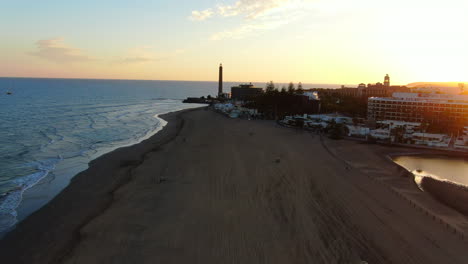 flying over maspalomas beach during the sunset and seeing the maspalomas lighthouse
