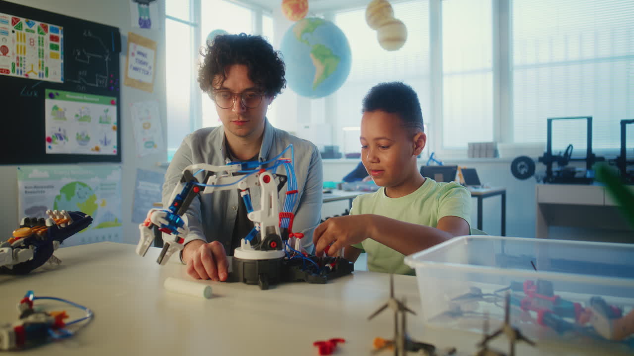 Teacher and Student Building a Robot in a Classroom