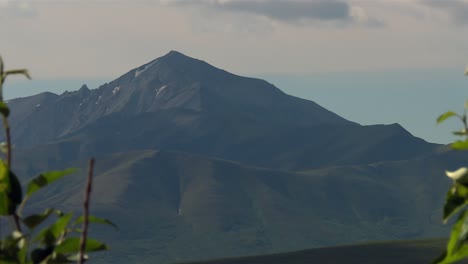 Closeup of peak rising above layered hills and forest, Denali National Park Alaska