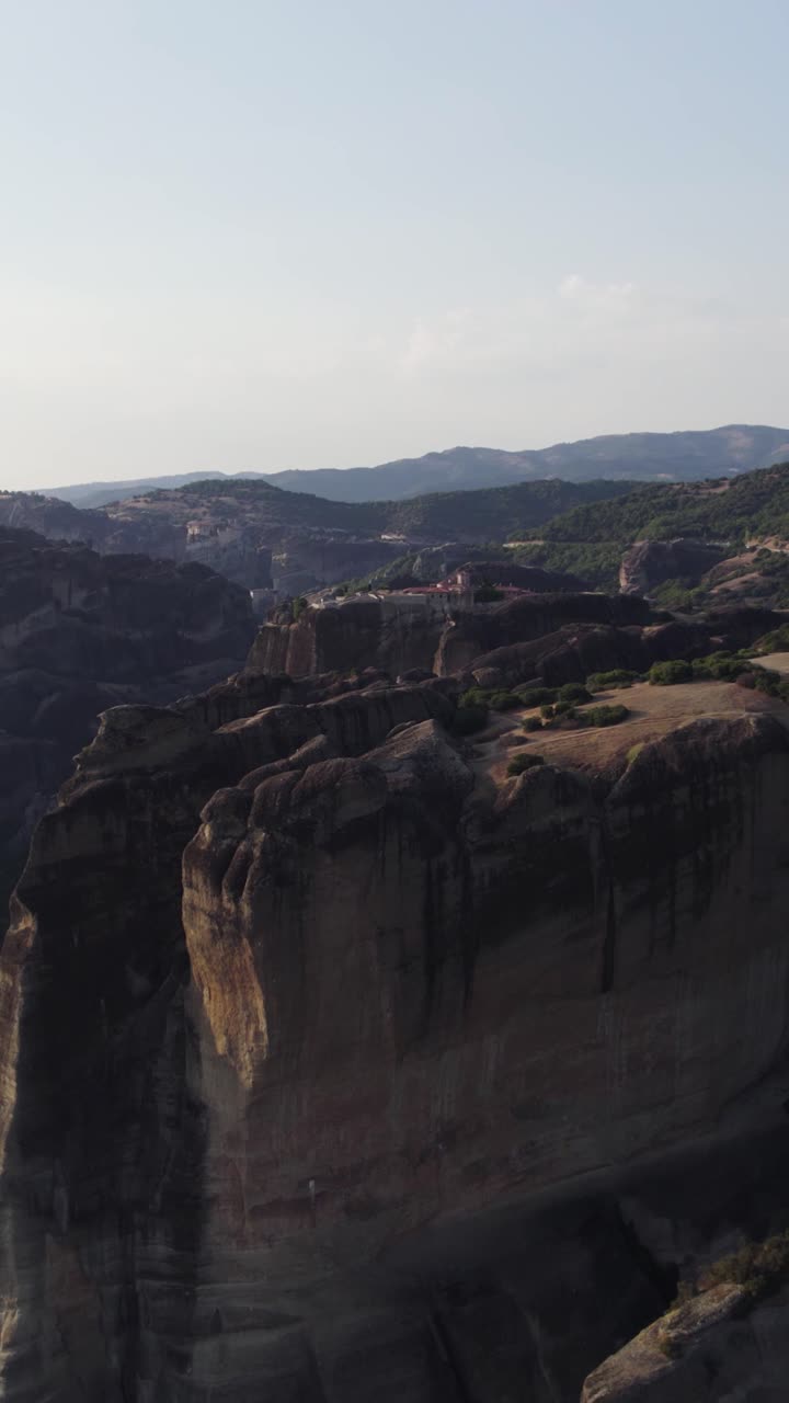 Vertical aerial view of Meteora in Greece, featuring stunning rock formations and its UNESCO World Heritage cliffs