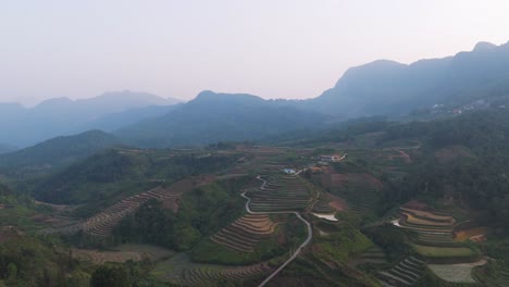 explore ha giang’s misty village from above, with serene rice fields, rural roads, and traditional homes. drone footage that captures the peaceful charm of vietnam’s northern countryside.