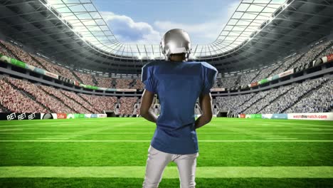 american football player with ball raising his arms