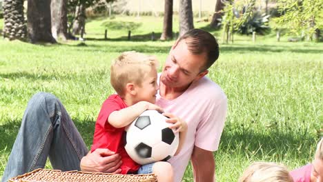 father and son talking in a park