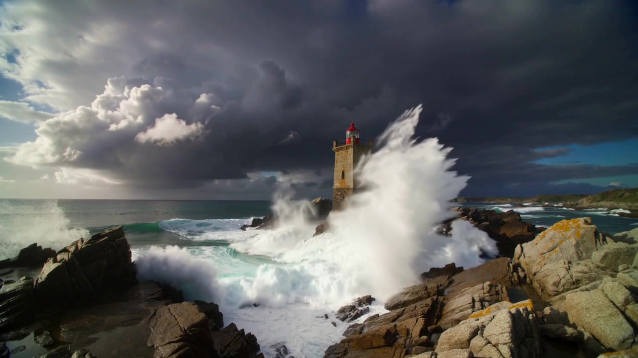 Incoming swell pushing towering waves striking stone lighthouse on rocky outcrop, red lantern roof