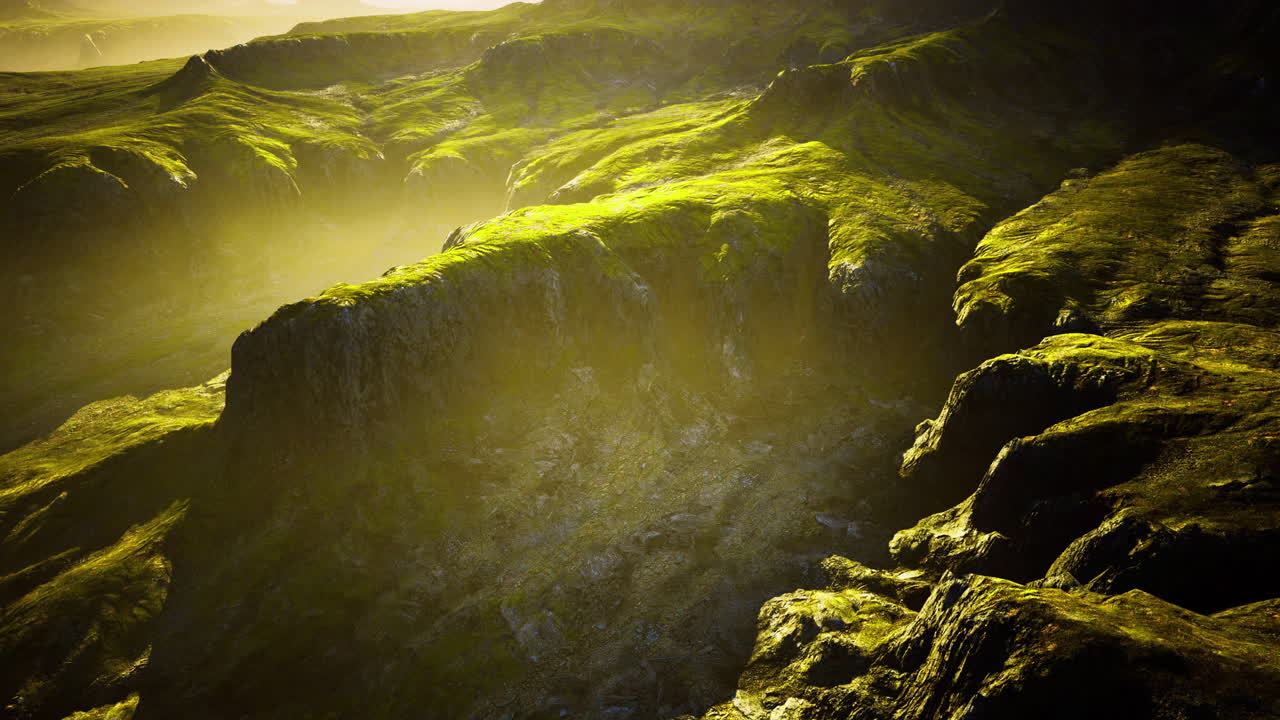 Lush green hills with soft sunlight illuminating the rugged terrain