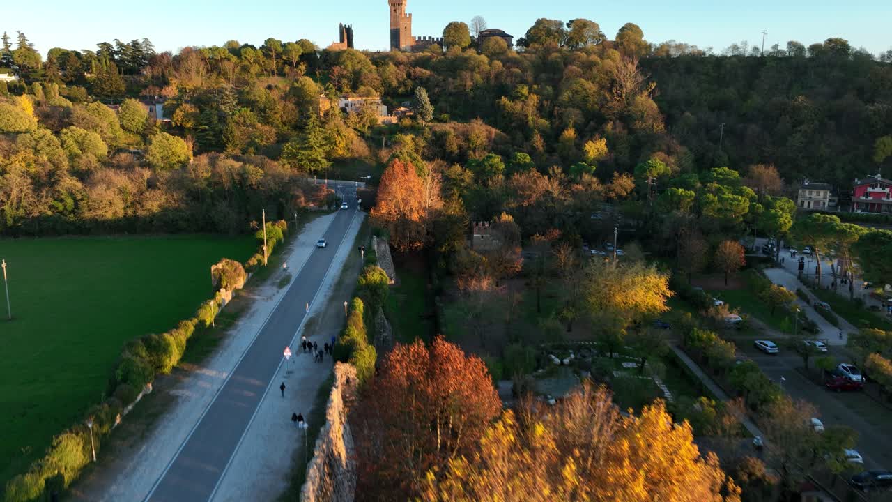 Aerial Bottom up Forward Drone Shot, of Valeggio's Castle over Visconteo's Bridge with cars Crossing at Golden Hour
