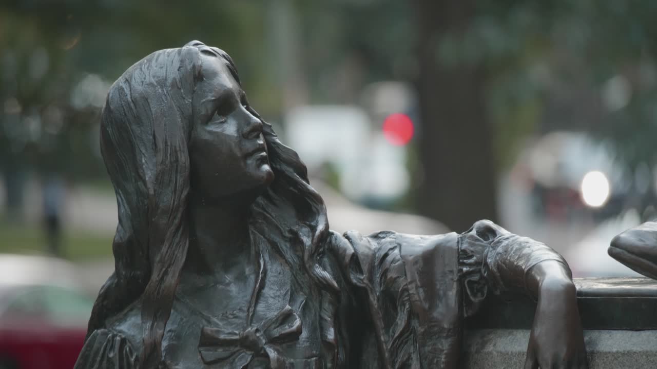 A close-up of a bronze statue of a woman.