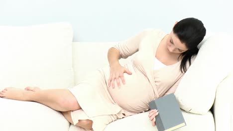 attentive pregnant woman touching her belly