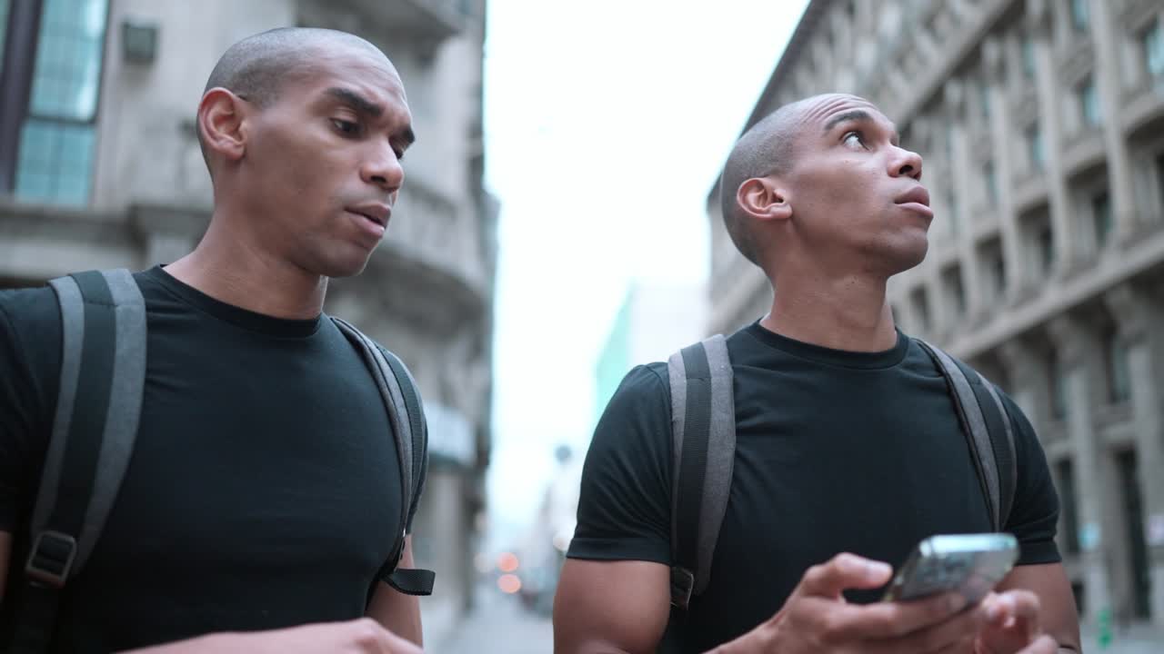 Two pensive brothers looking for an address on map in phone