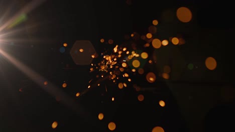 orange sparks of light against black background