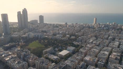 aerial view of the coastal town of bat yam on the shores of the mediterranean sea as panorama skyline and urban seascape, israel. top view of residential city view middle east buildings and streets shot houses at the horizon.