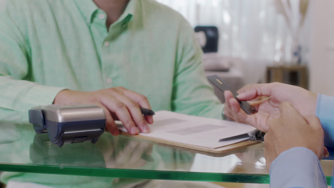 Manager Accepting Customers Payment by Credit Card