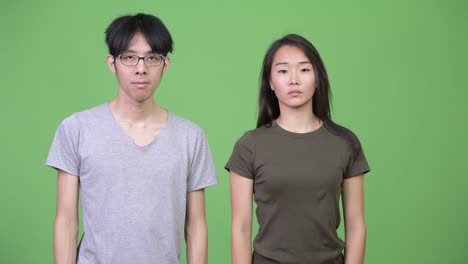 young asian couple with stop gesture together