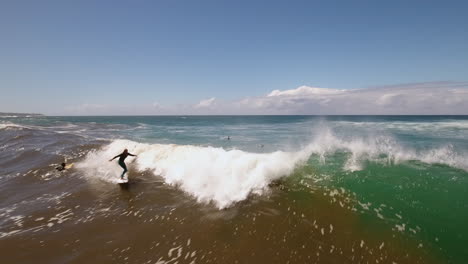 cinematic aerial ocean surfing along coast of south africa