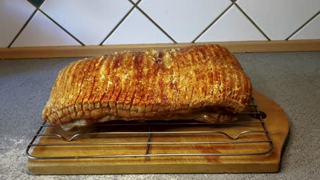 4k60 the roast pork with crackling is resting before cutting the roast - dolly forward shot