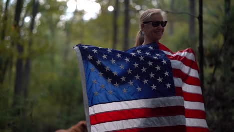 closeup of pretty blonde woman dancing with an american flag and spinning it around her