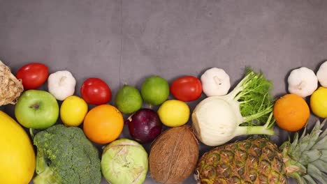 organic healthy fruits and vegetables ordered on the bottom of kitchen table. stop motion