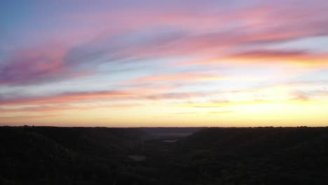 colorful sunset over valley with forest
