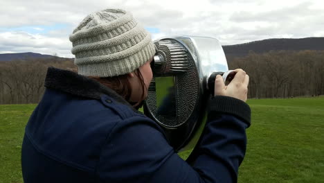 caucasian woman looking through binoculars