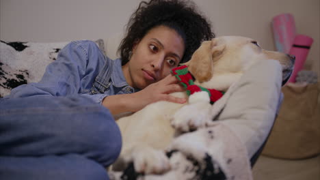 woman caresses dog, yellow labrador retriever relaxes with owner, beautiful girl cuddling her soft, fluffy puppy, pure love, cozy, chilling at home with pets, therapy animal, pet sitting, gentle breed