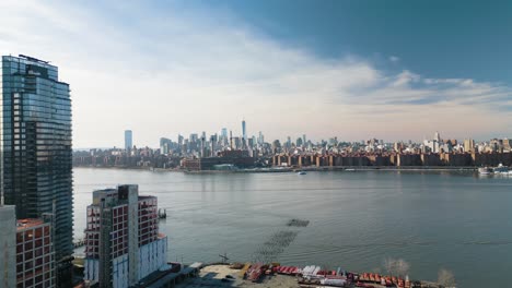 establishing aerial shot of manhattan skyline from brooklyn on sunny day