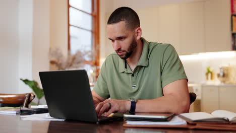 man working on laptop at home
