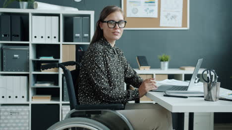 woman in wheelchair working in office