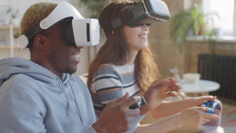 cheerful couple playing video game on vr headsets