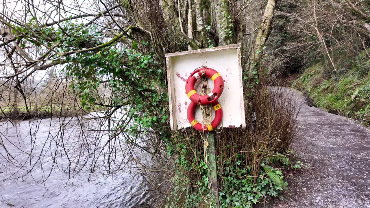 slow motion river Nore with lifeboats and riverside trails at Inistioge Kilkenny Ireland
