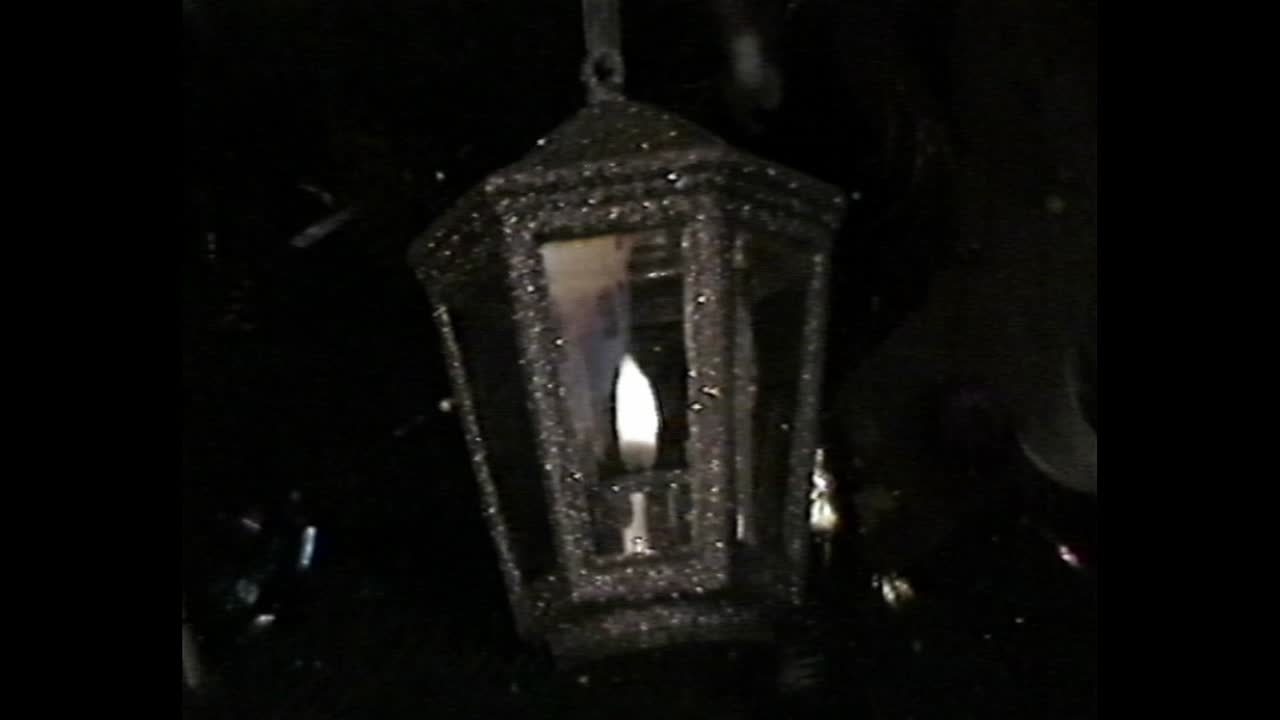 Christmas tree with candle and car ornaments in VHS style