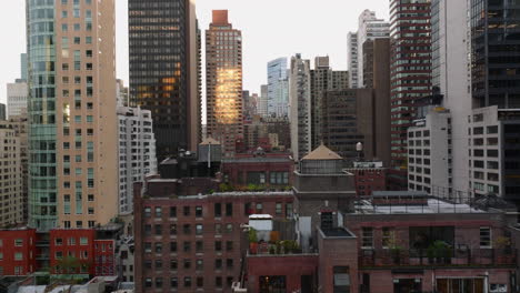 Forwards-fly-between-tall-apartment-buildings-in-city.-Various-colour-facades.-Manhattan,-New-York-City,-USA