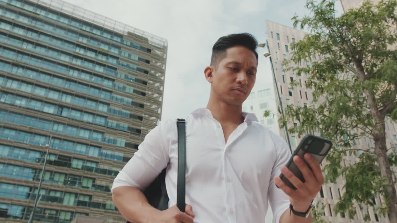 Man using phone outdoors in the city