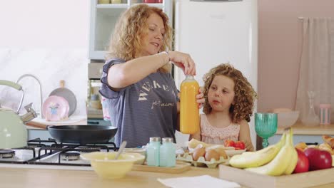 mother and daughter making breakfast