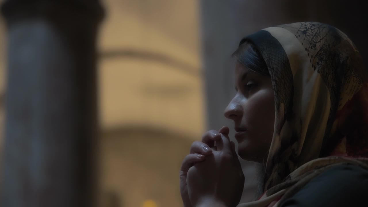 Young woman praying inside the church