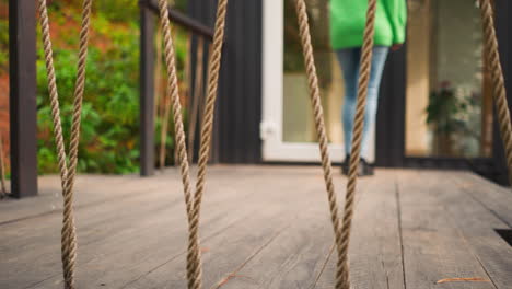 woman walking through a door on a deck