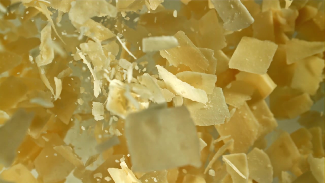 Parmesan Cheese Flakes Falling in Slow Motion