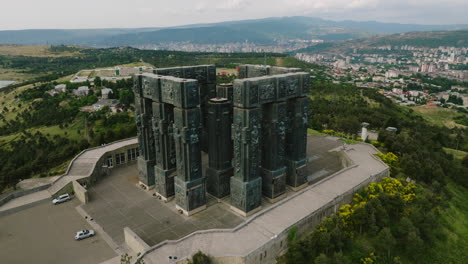 chronicle of georgia stone pillar monument on hill above tbilisi sea