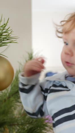 decorating christmas tree with baby