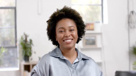 Portrait-of-happy-african-american-casual-businesswoman-in-office,-slow-motion