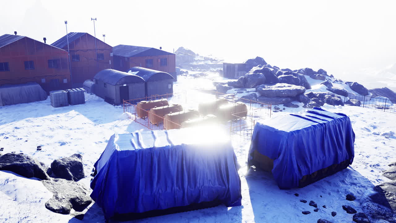 Vibrant blue coverings contrast against a snowy arctic landscape at dawn