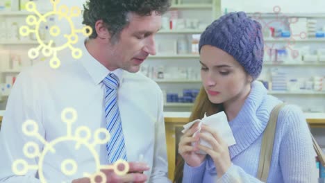 animation of macro covid-19 cells icons floating over caucasian woman wiping her nose