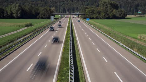 static day time lapse of a swiss highway amid green farm fields in switzerland