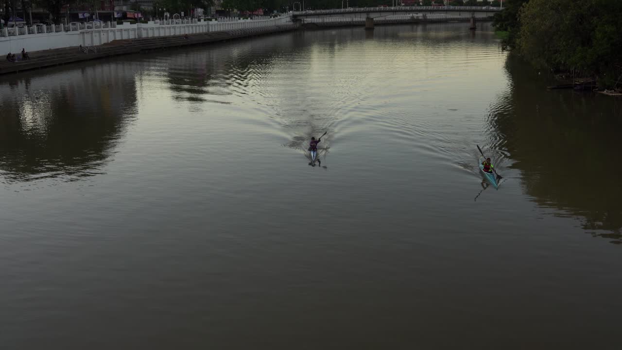 Kayaking on a calm river at sunset