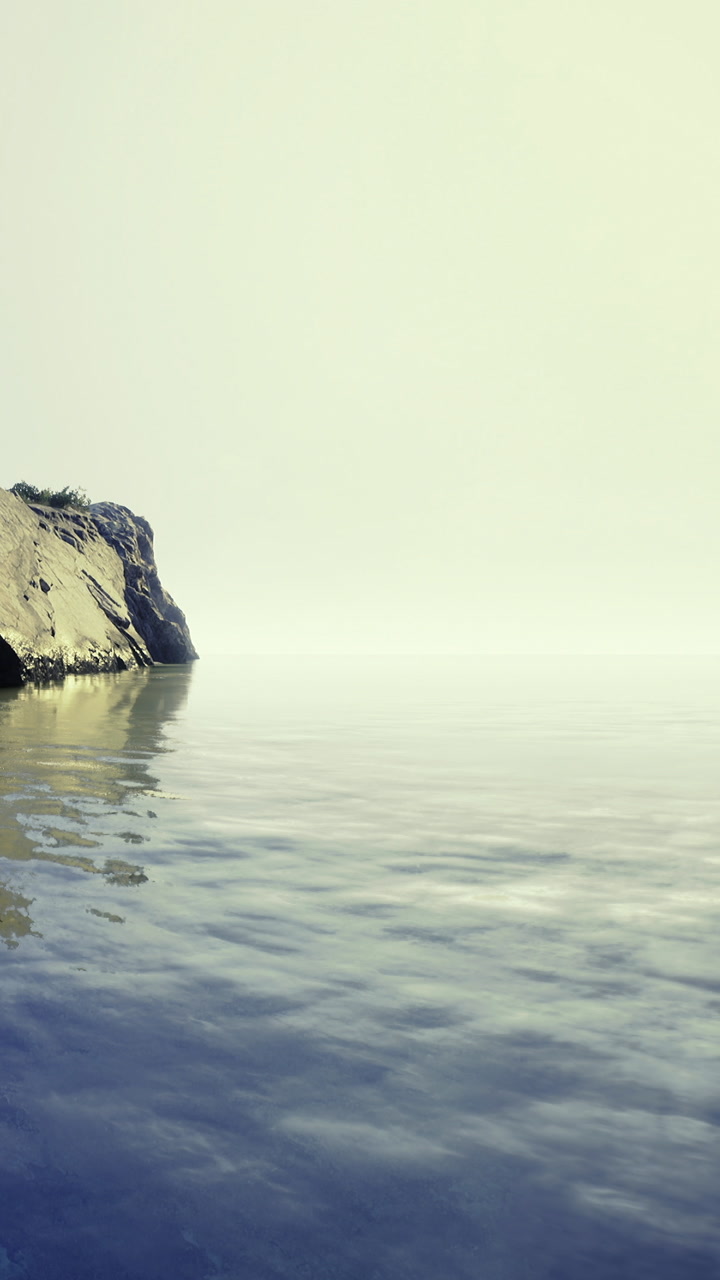 Beautiful shoreline with calm water and rocky cliff during the daytime