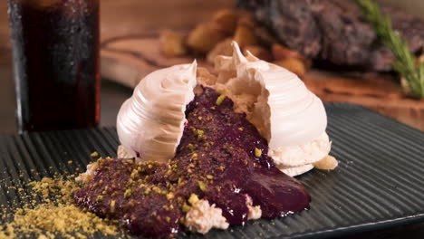 classic fine dining pavlova dessert with blackberry coulis spilling out, slider slow motion hd