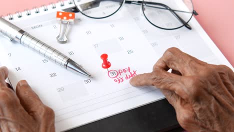 payday marked on calendar with elderly hands